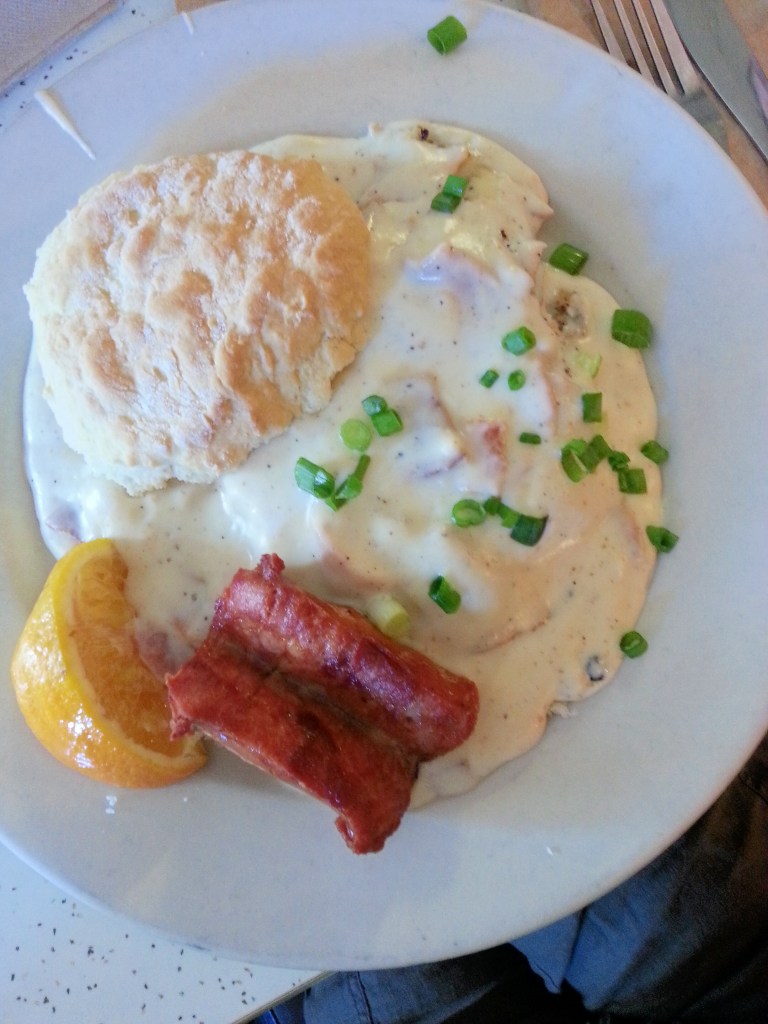 Sausage gravy over a fresh-baked biscuit, topped with andouille
